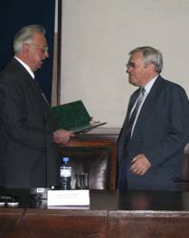 Prof Cristian Hera President of the Romanian Academy for Agricultural and Forestry Scinces (left) presenting the prestigious "Academic Merit" Award to Dr James, Chair and Founder of ISAAA 